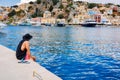 Panoramic view, aerial skyline of small haven of Symi island. Village with tiny beach and colorful houses located on