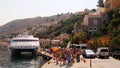 Travelers of King Saron passenger catamaran come ashore in the port of Symi, Symi island, Greece