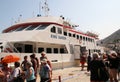 Travelers of King Saron passenger catamaran come ashore in the port of Symi, Symi island, Greece