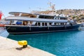 Cruise boat at the port of Gialos during the summer season. Symi island, Greece