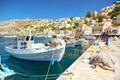 SYMI ISLAND, GREECE, JUNE 25, 2013: View on beautiful classic old piscatory sea boats ships, Greek sea port, gingerbread houses hi