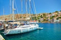 SYMI ISLAND, GREECE, JUNE,25, 2013: View on beautiful classic white yachts, Greek sea port, gingerbread houses on island hills, to