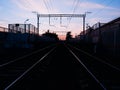 Symmetric two railway tracks during sunset background Royalty Free Stock Photo