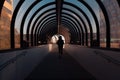 Symmetric view of a person walking on the modern arched bridge