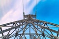 Symmetric view of power pylons against a beautiful coloured evening sky. Bottom view