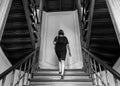 Woman walking the symmetric wooden stairs of the Mendelssohn museum, Leipzig, Germany