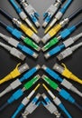 A symmetrical arrangement of various network cables on a black background. The Royalty Free Stock Photo