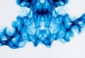 Symmetrical blue swirling smoke pattern on a white background Royalty Free Stock Photo