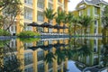 Symmetrical buildings and trees through water