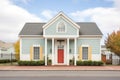 symmetrical front view of saltbox with elegant shutters