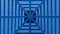 Symmetrical pattern obtained from a blue patio wooden cover or a pergola with a roof against clear blue sky Royalty Free Stock Photo