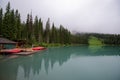 Symmetrical picture of the trees reflected on the surface of Emerald lake. Royalty Free Stock Photo