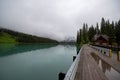 Symmetrical picture of the trees reflected on the surface of Emerald lake. Royalty Free Stock Photo