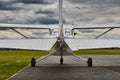 Symmetrical rear view of Cessna 172 Skyhawk 2 airplane on a runway with dramatic sky background. Royalty Free Stock Photo