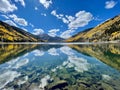 Symmetrical reflection shot on the lake surface of mountain tops, blue sky above, in Colorado Royalty Free Stock Photo