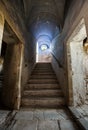 Symmetrical shot of a marble staircase in an abandoned monastery