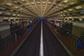 Symmetrical underground view shows both platforms of Gallery Place-Chinatown station with commuters and lighting features Royalty Free Stock Photo