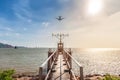 Symmetrical View of Pier and Horizon at Sunset with Plane, Hong Kong