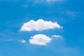 Symmetrical white clouds against the blue sky.