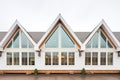 symmetrical windows flanking a farmhouse gable