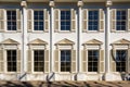 symmetrical windows in sunlight on greek revival building