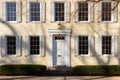 symmetrical windows in sunlight on greek revival building