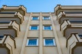 Symmetry of balconies and windows against the blue sky Royalty Free Stock Photo