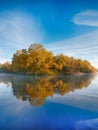 Symmetry reflection on the autumn river. Sunrise. Royalty Free Stock Photo