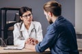 Sympathetic Female Doctor Cheering Her Patient Up