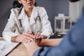 Sympathetic Female A Doctor Supporting Her Patient