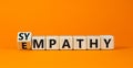 Sympathy or empathy symbol. Turned wooden cubes and changed the concept word Empathy to Sympathy. Beautiful orange table orange Royalty Free Stock Photo