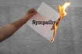 Sympathy word text on fire with burning paper Royalty Free Stock Photo