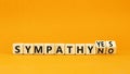 Sympathy yes or no symbol. Concept words Sympathy yes or Sympathy no on wooden cubes. Beautiful orange table orange background. Royalty Free Stock Photo