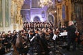 Symphonic orchestra performing live in the baroque basilica.