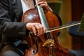 Symphonic orchestra performing on stage and playing a classical music concert, cellist in the foreground