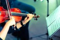 Symphony music. Woman playing the violin in orchestra. Vintage toned Royalty Free Stock Photo