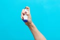 Symptoms of asthma. A woman`s hand holds an inhaler with medicine, pressing the pump. Blue background. Copy space