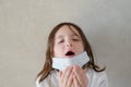 Symptoms of coronavirus covid 19 concept of small little girl sneeze and cough wearing medical mask Royalty Free Stock Photo