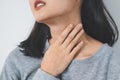 Symptoms from flu season in winter concepts. Close up woman touching her neck and suffering from sore throat Royalty Free Stock Photo