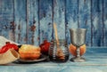 On the table in the synagogue are the symbols of Rosh Hashanah apple and pomegranate, shofar talith