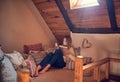 Synching her devices at home. a young woman texting on her smartphone while relaxing in her bedroom at home.