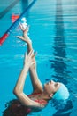 Synchronized girl working out tricks in the pool. Synchronized swimming, sports in the water. Jumps out of the water Royalty Free Stock Photo