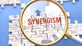 Synergism and related ideas on a puzzle pieces. A metaphor showing complexity of Synergism analyzed with a help of a mag Royalty Free Stock Photo