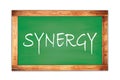 SYNERGY text written on green school board Royalty Free Stock Photo