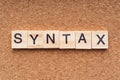 SYNTAX word written on wood block.