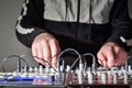 Synthesizer control knobs against the background of the musician`s blurry hands Royalty Free Stock Photo