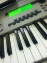 Synthesizer keyboard music instrument and green LCD screen Royalty Free Stock Photo