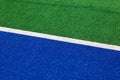 Synthetic hockey sideline closeup blue and green Royalty Free Stock Photo