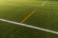 Synthetic turf of soccer field at sunset Royalty Free Stock Photo