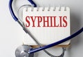 SYPHILIS word on notebook with medical equipment on background